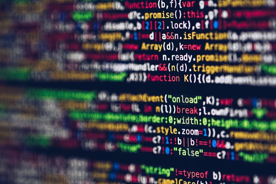 A close-up digital photograph displaying a computer screen filled with multicoloured lines of programming code, including syntax elements such as functions, variables, and commands, with a focus on th